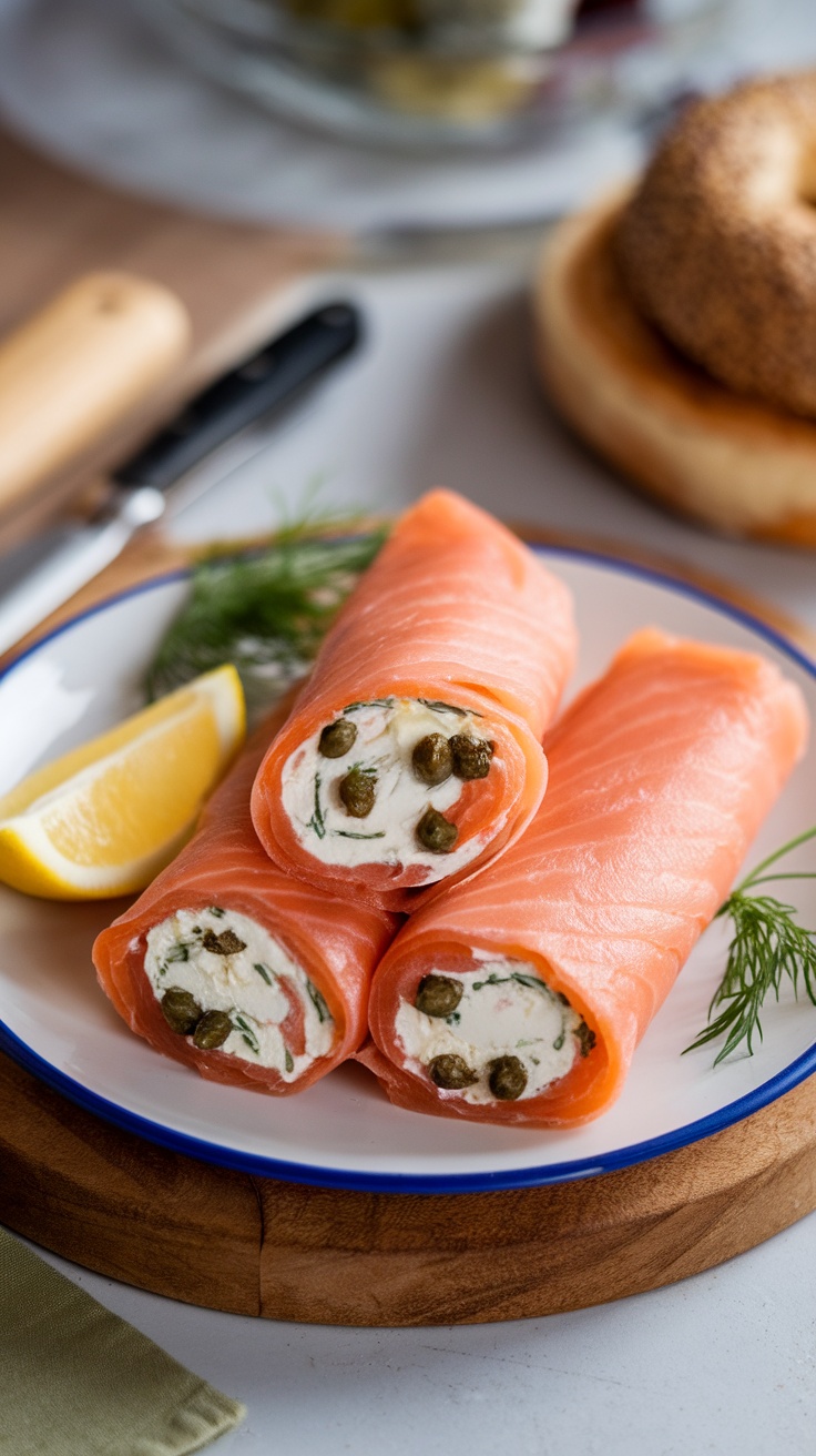 Smoked salmon and cream cheese wraps on a plate with a lemon slice.